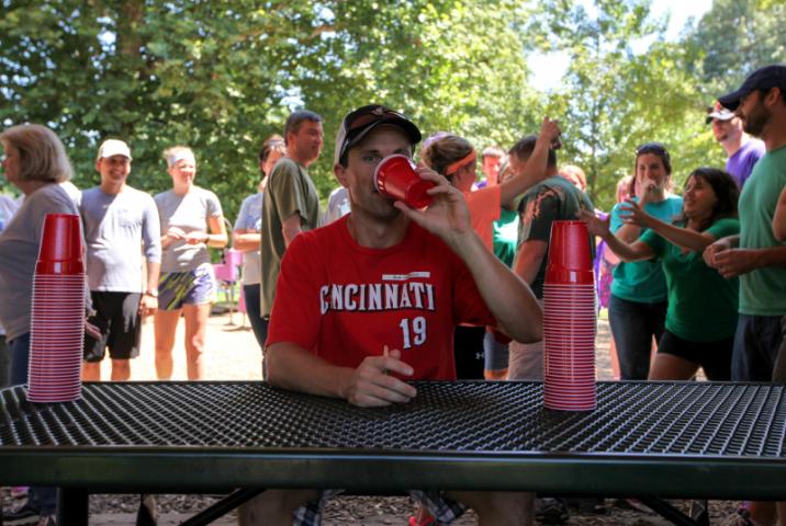 Joe sits with the cups (more hijinx in the background)