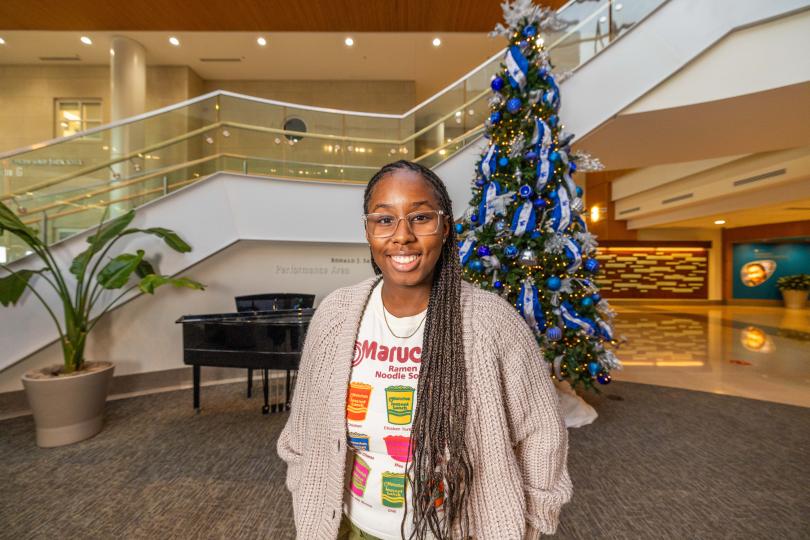 portrait of a student near a piano at a Christmas ree